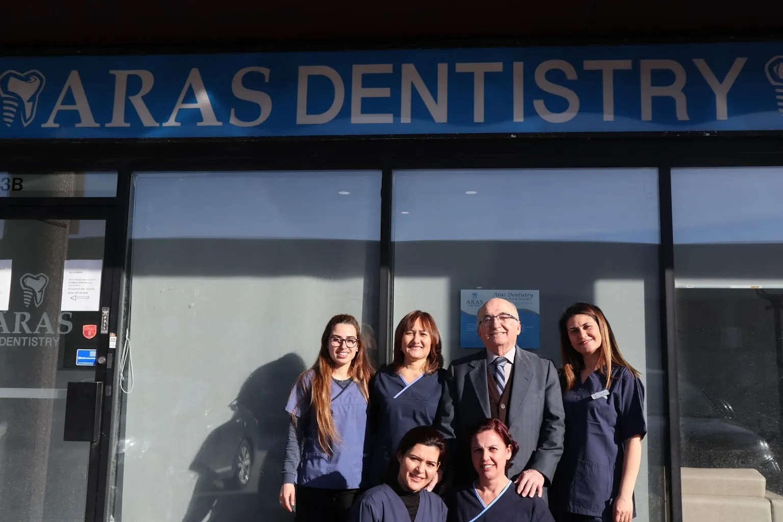 The Aras Dentistry team outside the clinic entrance on Dufferin Street
