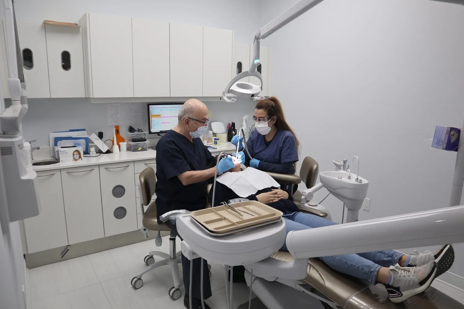 Dentist treating a patient in a modern treatment room at Aras Dentistry